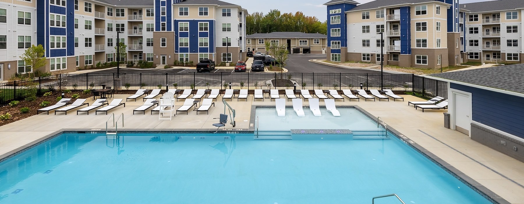 a swimming pool with lounge chairs