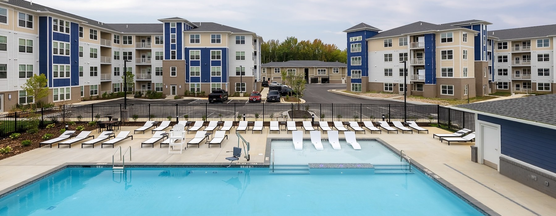 a swimming pool with lounge chairs
