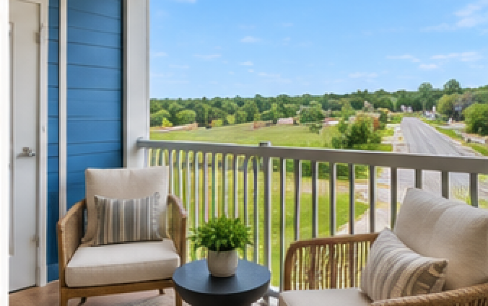 Private balcony in the A3.4 floor plan at Ironwood at Waldorf Station with outdoor seating and open neighborhood views
