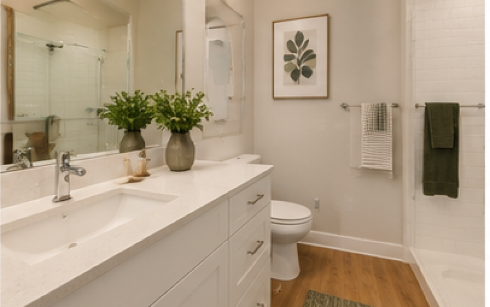 A3.4 apartment bathroom at Ironwood at Waldorf Station featuring a large vanity, modern finishes, and a glass-enclosed shower
