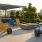 outdoor fire pit surrounded by lawn chairs and side tables
